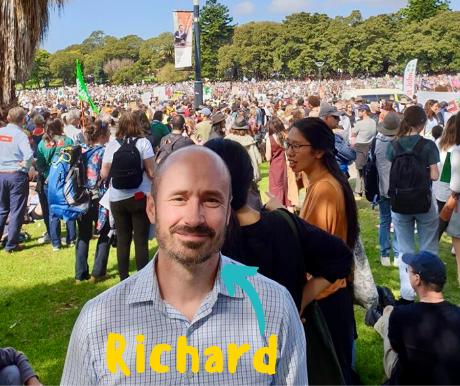 A picture of Richard, a male Hume employee, surrounded by people at a protest.